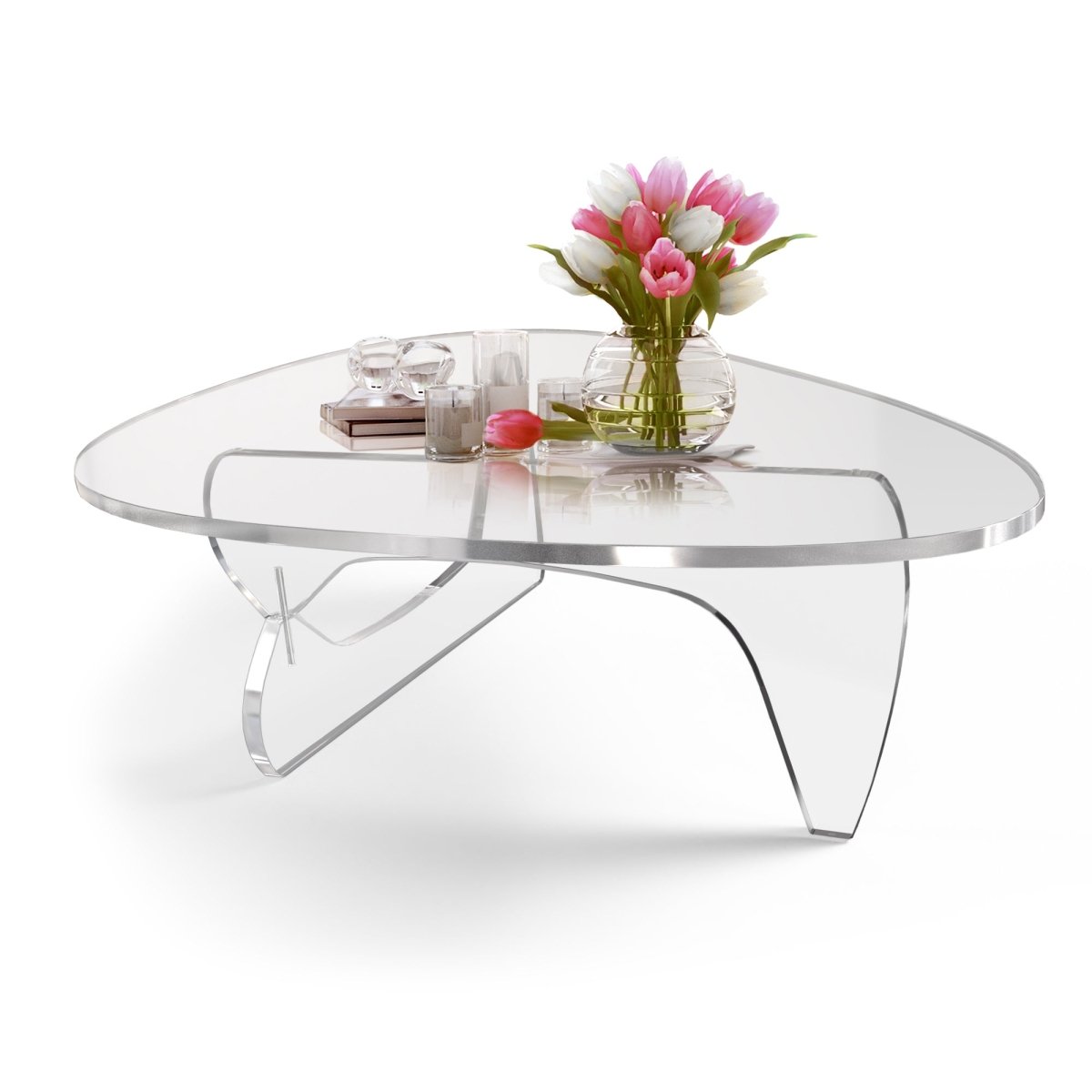 Noguchi style clear acrylic table with flowers and decorations on top.